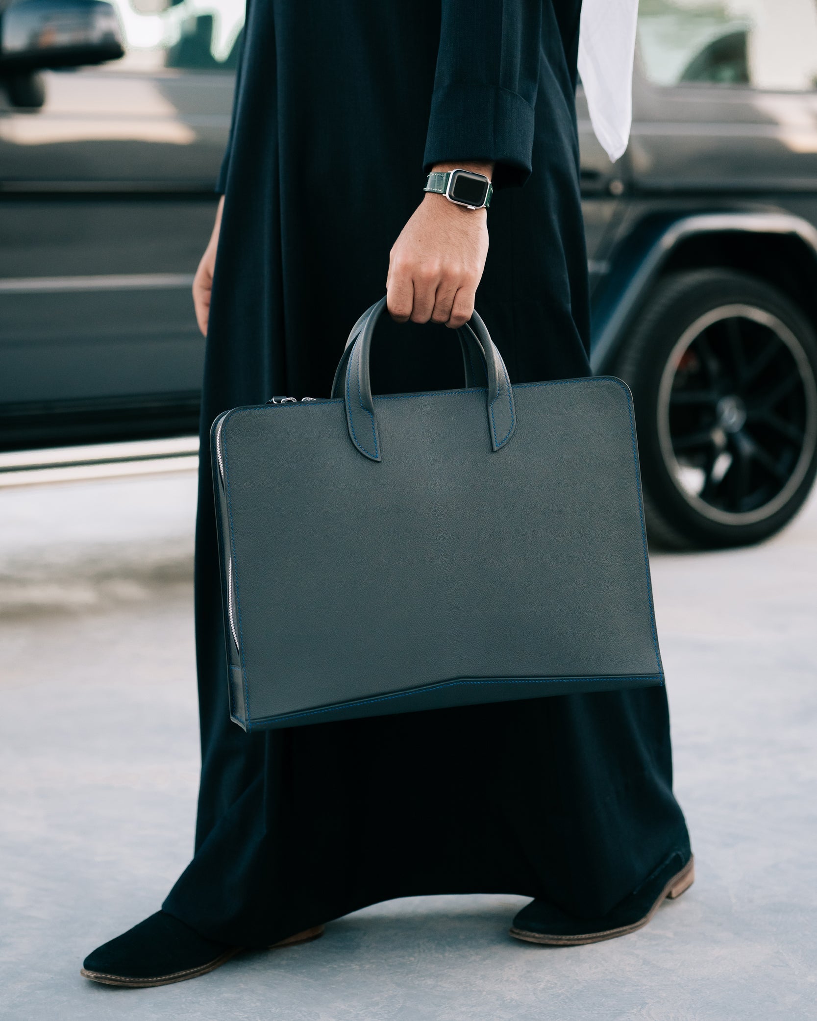 Man walking with Kinan Leather Briefcase in Black Textured Goatskin from France